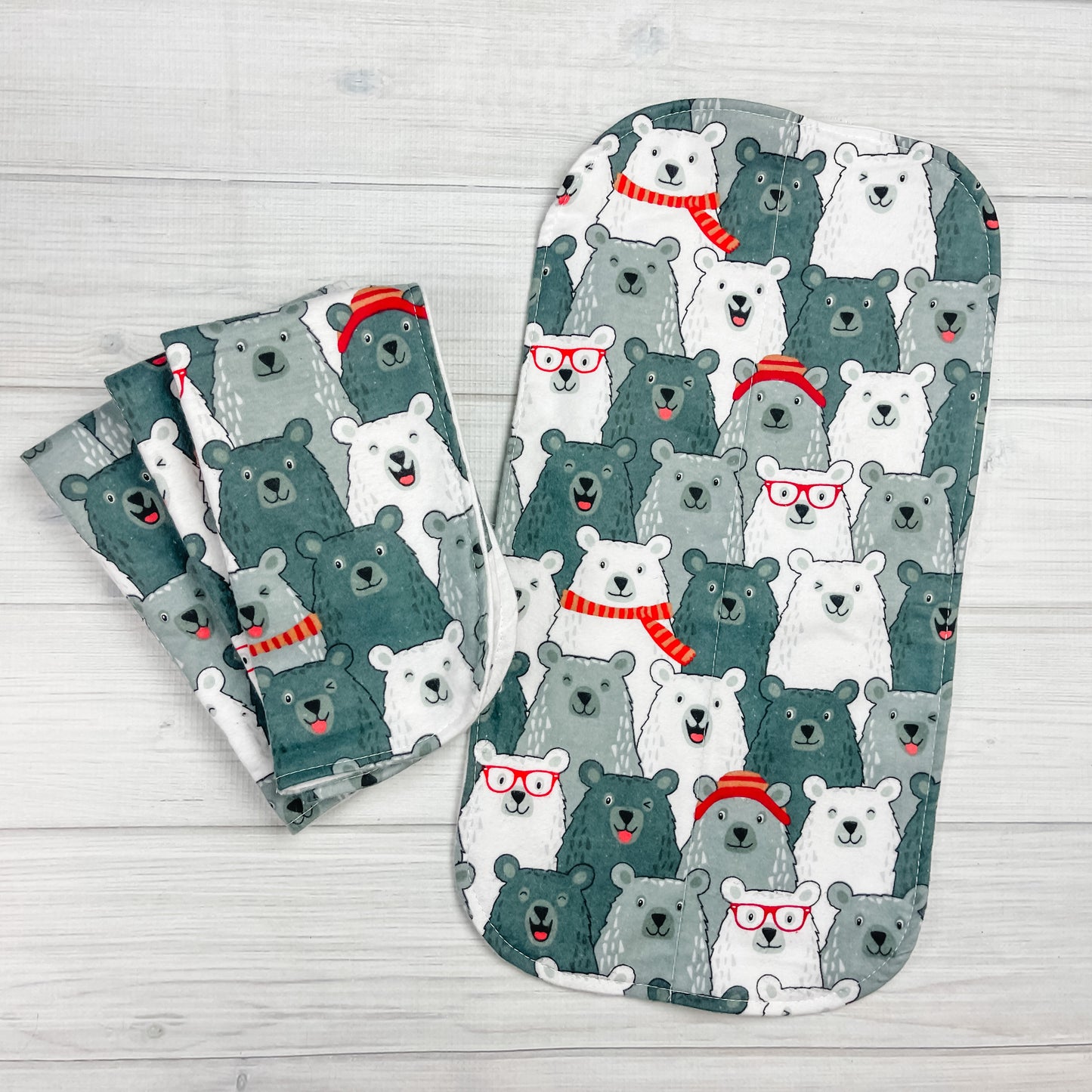 Flannel burp clths with Smiling & Laughing bears in shades of gray. the bears are wearing hats, scarves and glasses in red and orange.