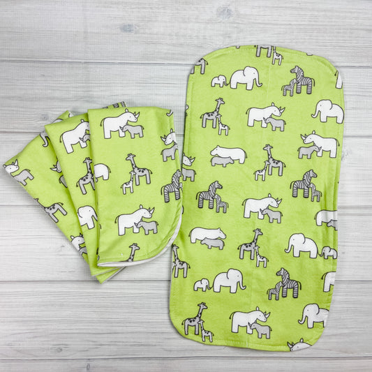 Green flannel burp cloths with elephants, hippopotamus, giraffes, zebras and rhinoceros adult and baby in white and gray. 