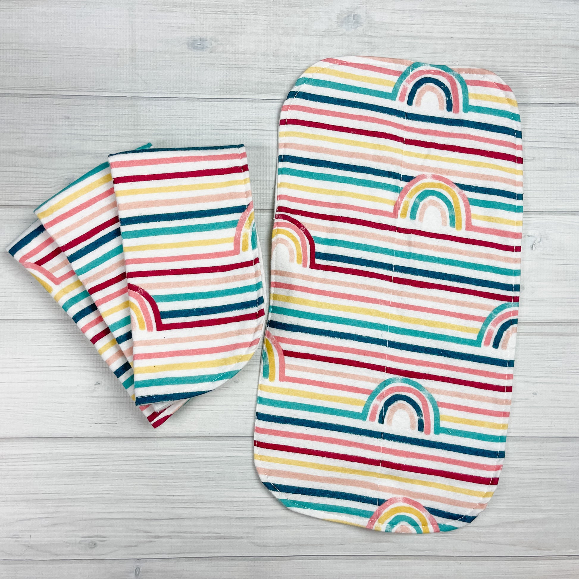 rainbow stripped flannel burp cloths. colors include: teal, navy blue, pink, coral, yellow, maroon 